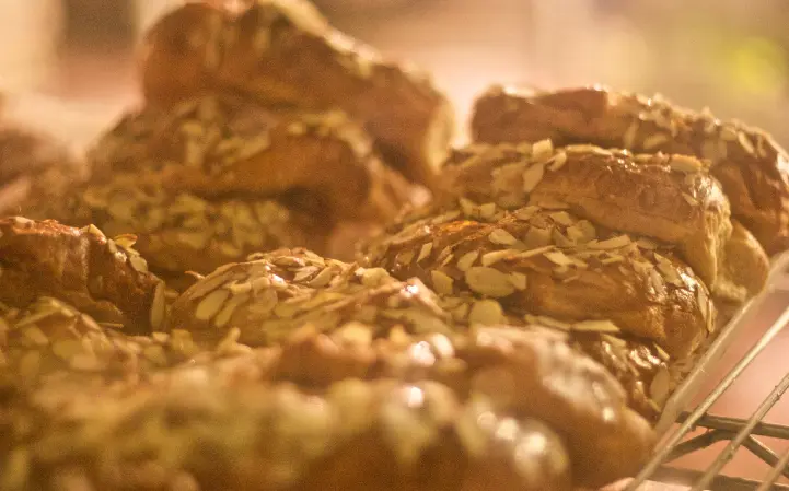 Almond croissants for sale in display case at Au Bon Pain