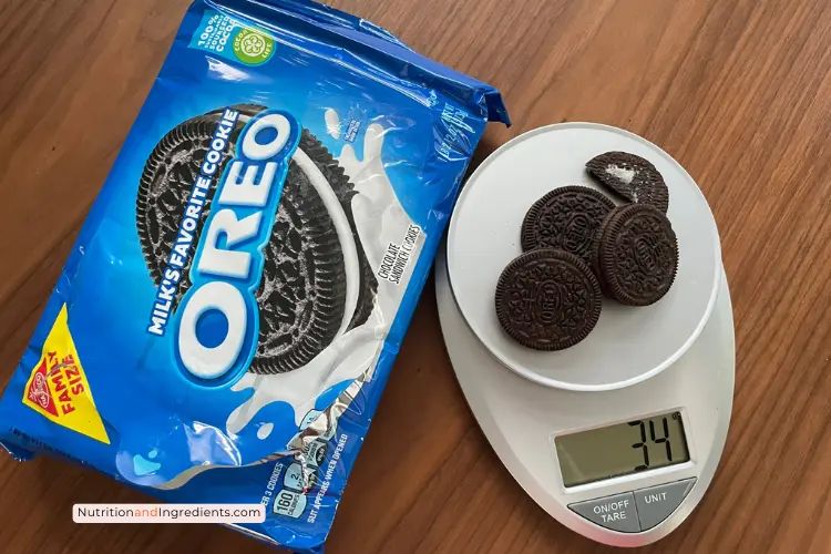 Three OREO cookies on scale showing 34 grams, which equals one serving.