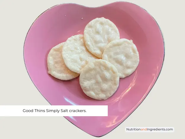 Good Thins Simply Salt Crackers served on pink plate shaped like a heart.