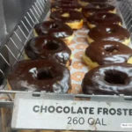 Display of chocolate frosted donuts at Dunkin'.