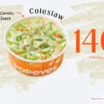 Side order of coleslaw from Popeyes fast food restaurant with text '140 calories'.