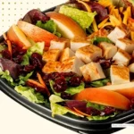 Salad with apple, cranberries, and chicken.