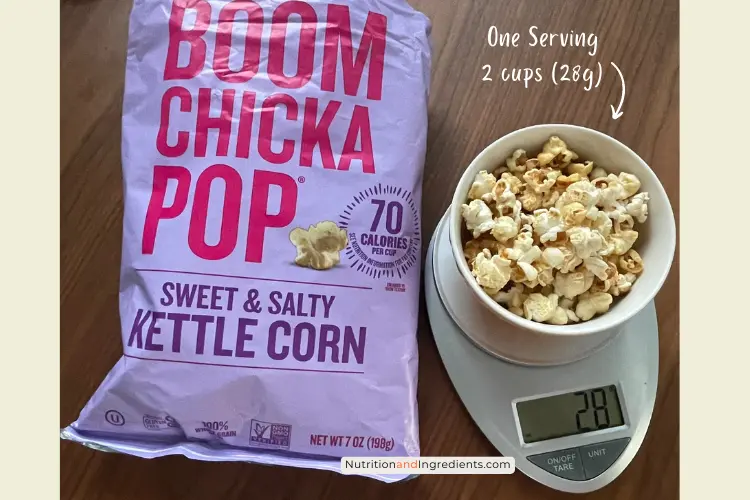 Bowl of kettle corn on scale illustrating serving size of 28 grams.