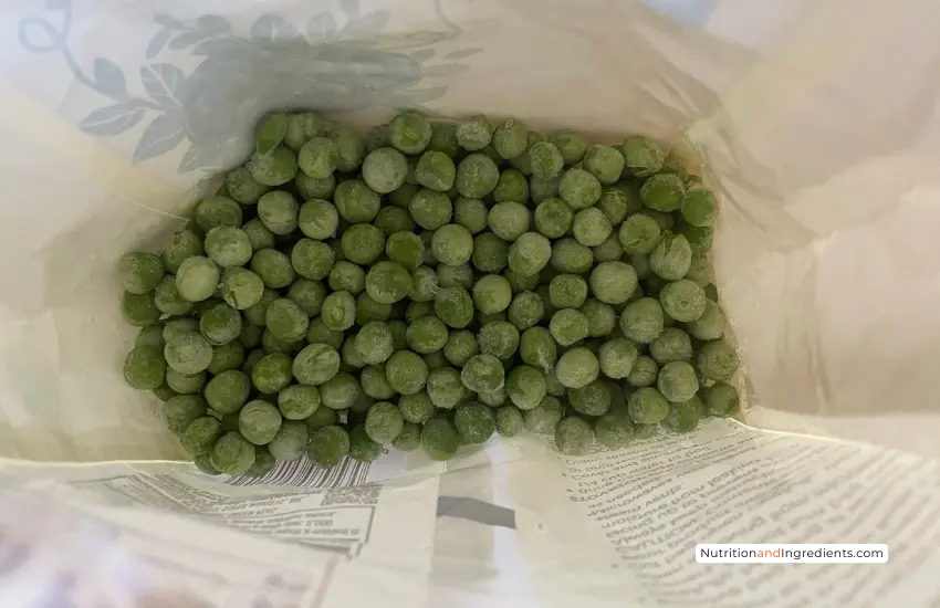 Frozen green peas inside bag.