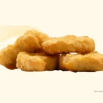 Stack of four chicken nuggets from McDonald's.