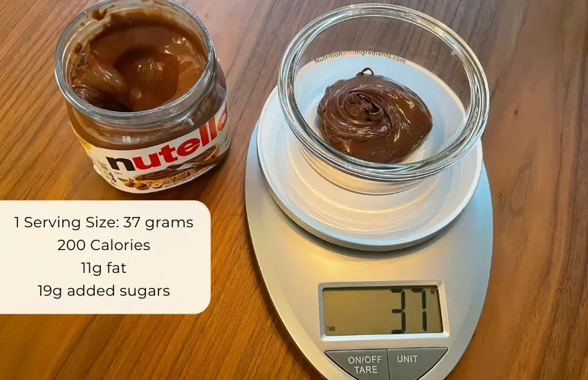 Nutella in bowl on scale to illustrate serving size of 37 grams.