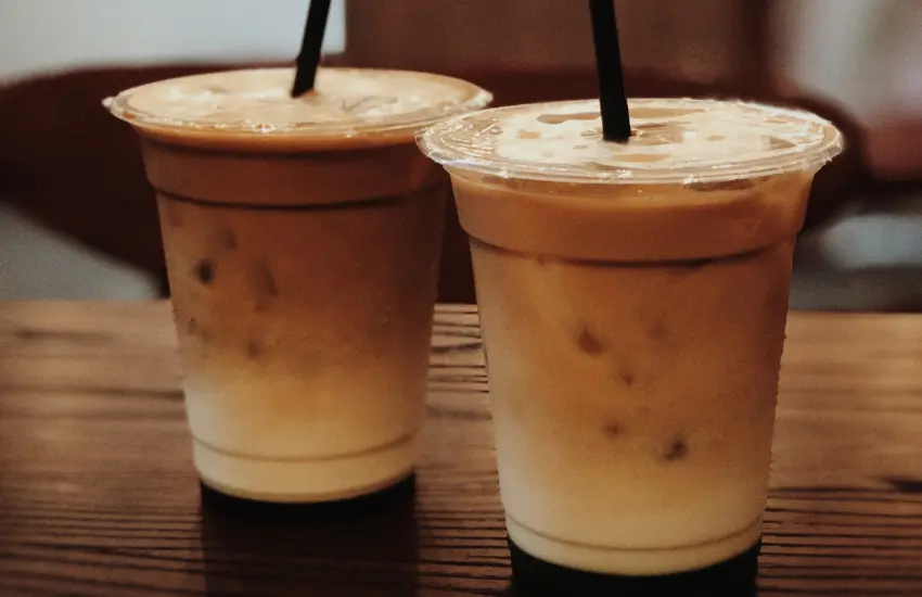 Two lattes on counter.