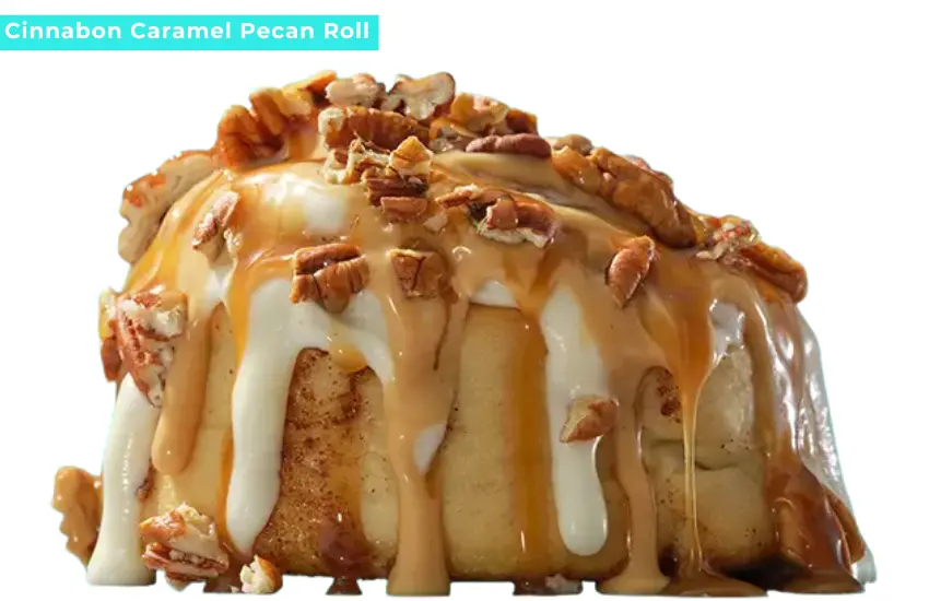 Cinnabon caramel and vanilla frosted cinnamon roll topped with pecans